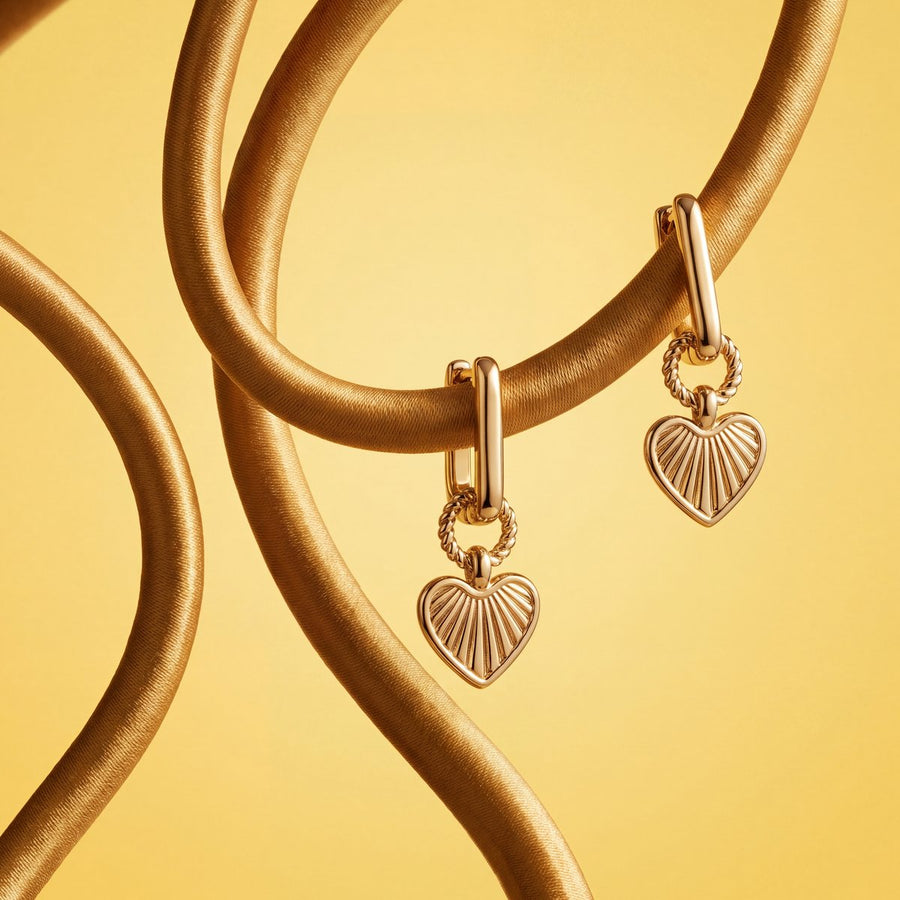 Gold heart drop earrings on a golden satin cord